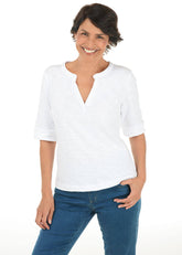 Woman wearing a white shirt and blue jeans on a white background