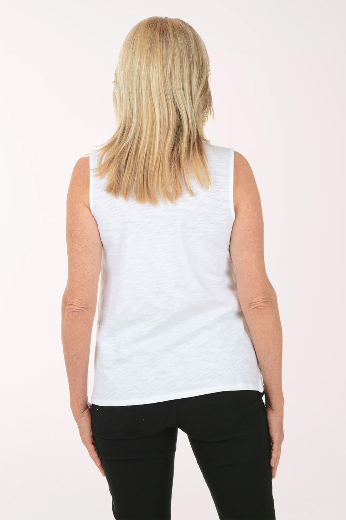 Woman wearing a white sleeveless top with a cowl neckline on a white background