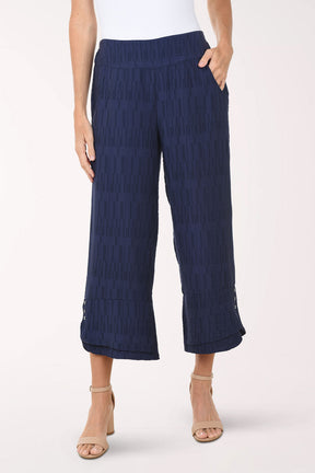 Navy blue textured pants worn by a person on a white background