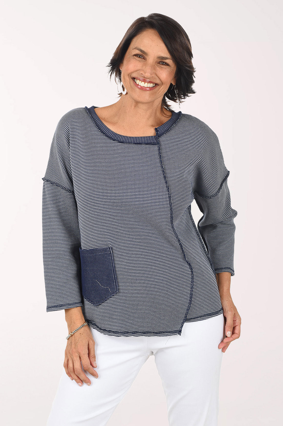 Woman wearing a blue and white striped shirt with a pocket on a white background