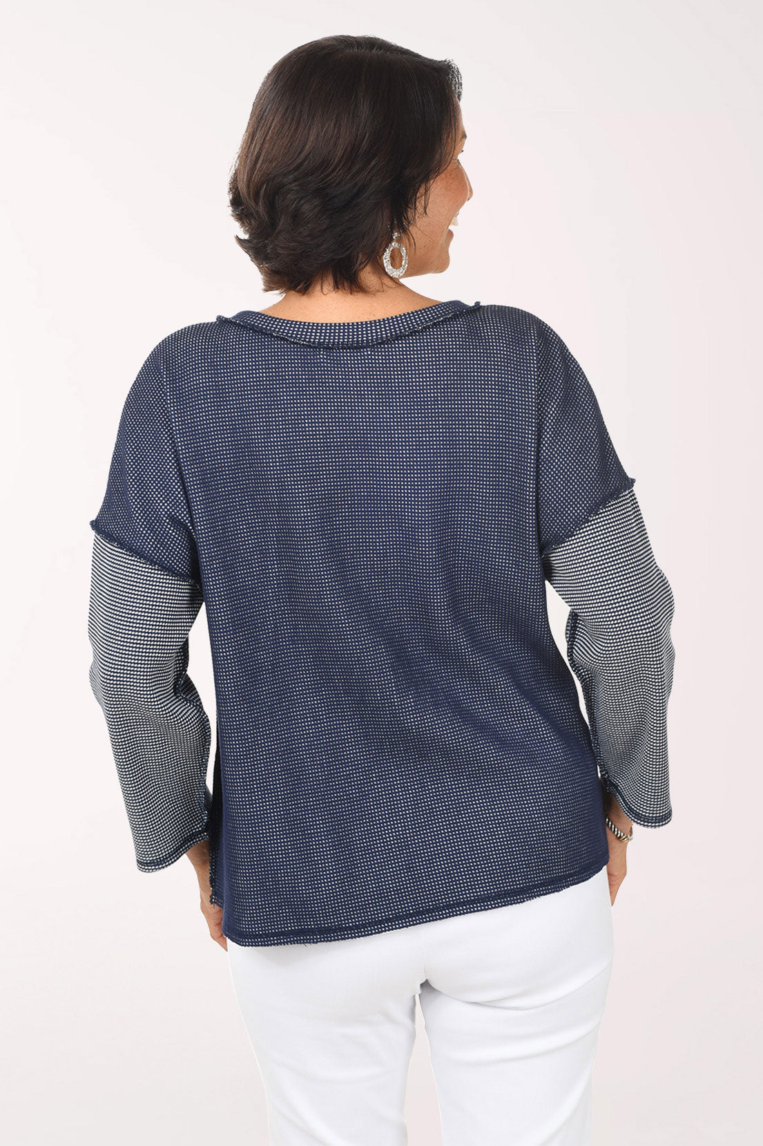 Woman wearing a blue and white striped shirt with a pocket on a white background