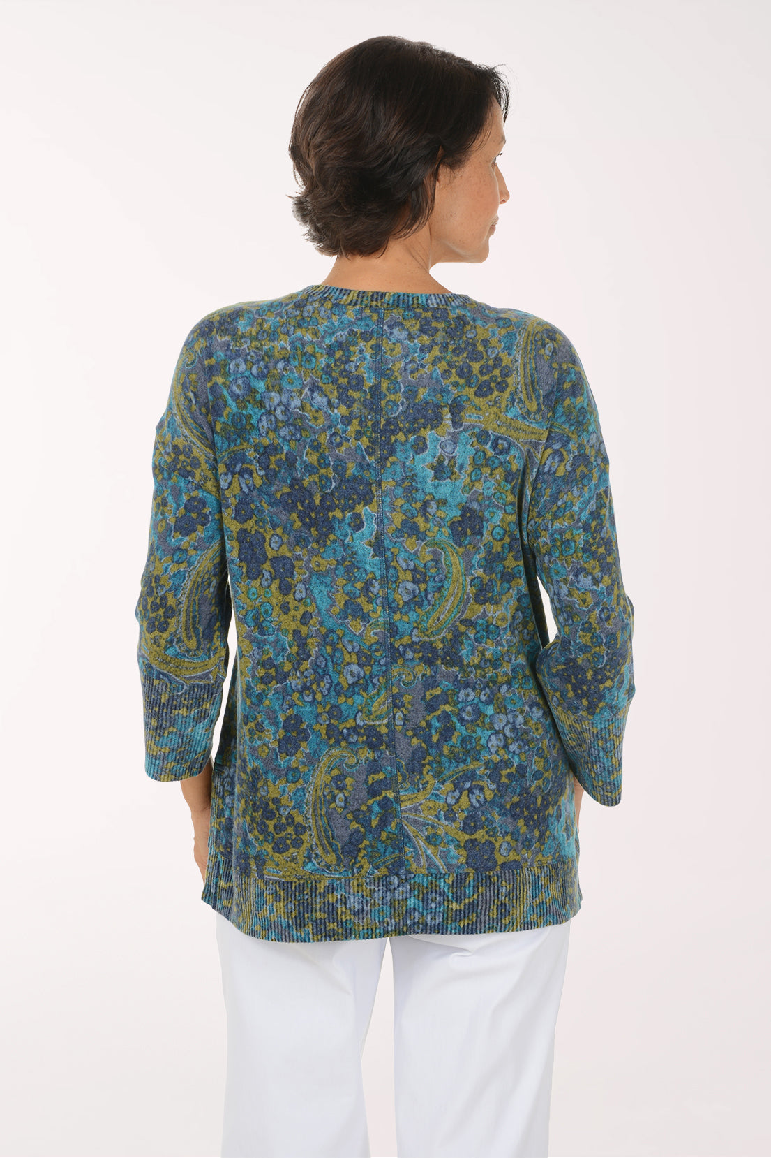 Woman wearing a blue multi colored paisley knit top with 3/4 sleeves