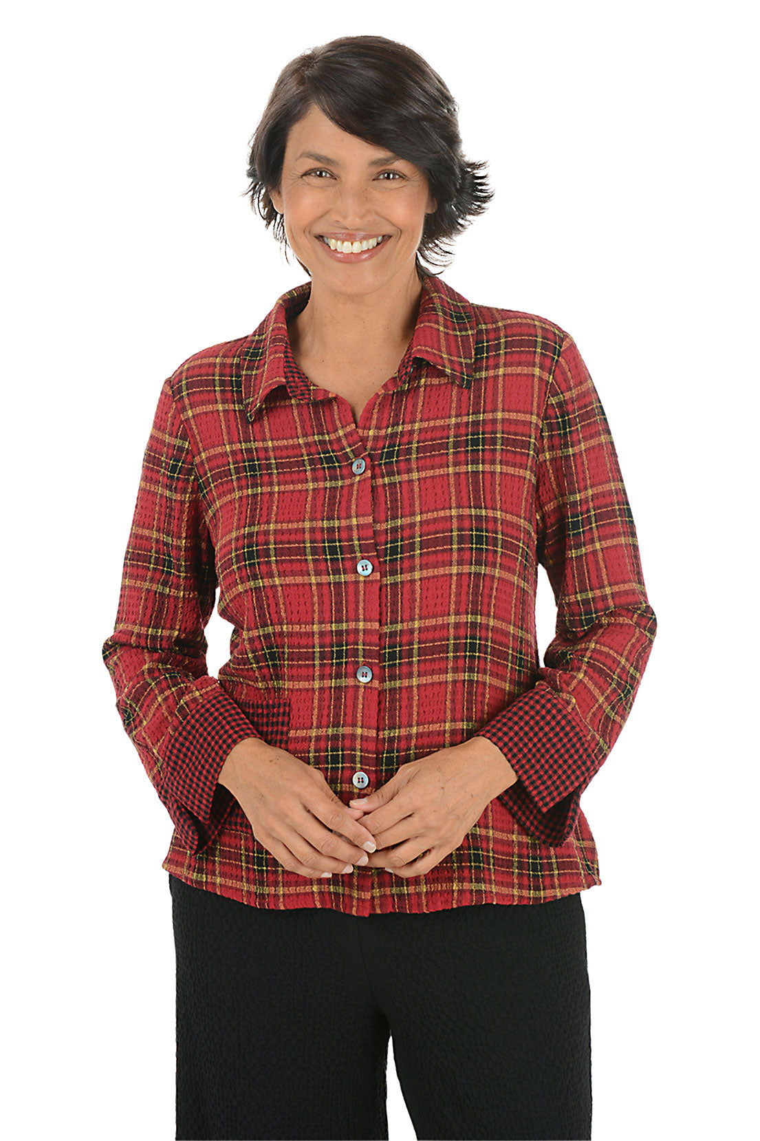 Woman wearing a red plaid shirt on a white background.