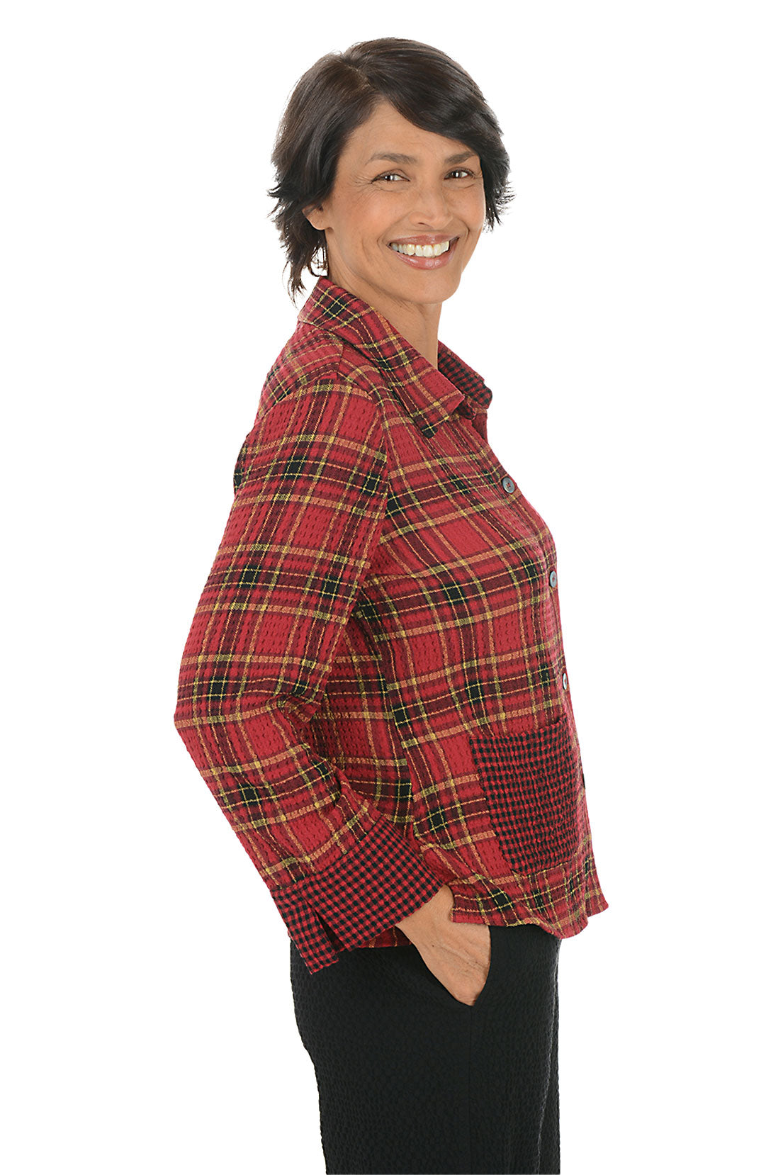 Woman wearing a red plaid shirt on a white background. Side shot.