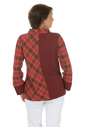 Woman wearing a contrasting plaid red and yellow shirt and white pants on a white background. Back shot.