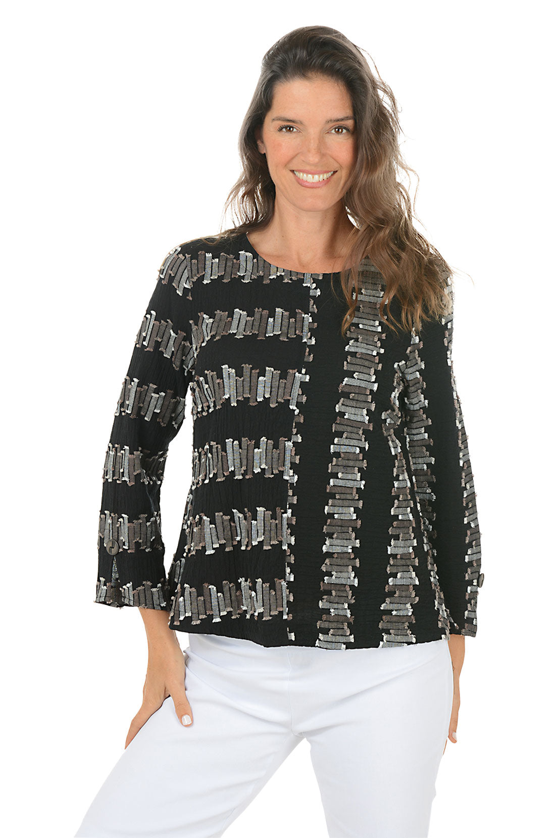 Woman wearing a black 3/4 sleeve shirt with silver embellishments on a white background.