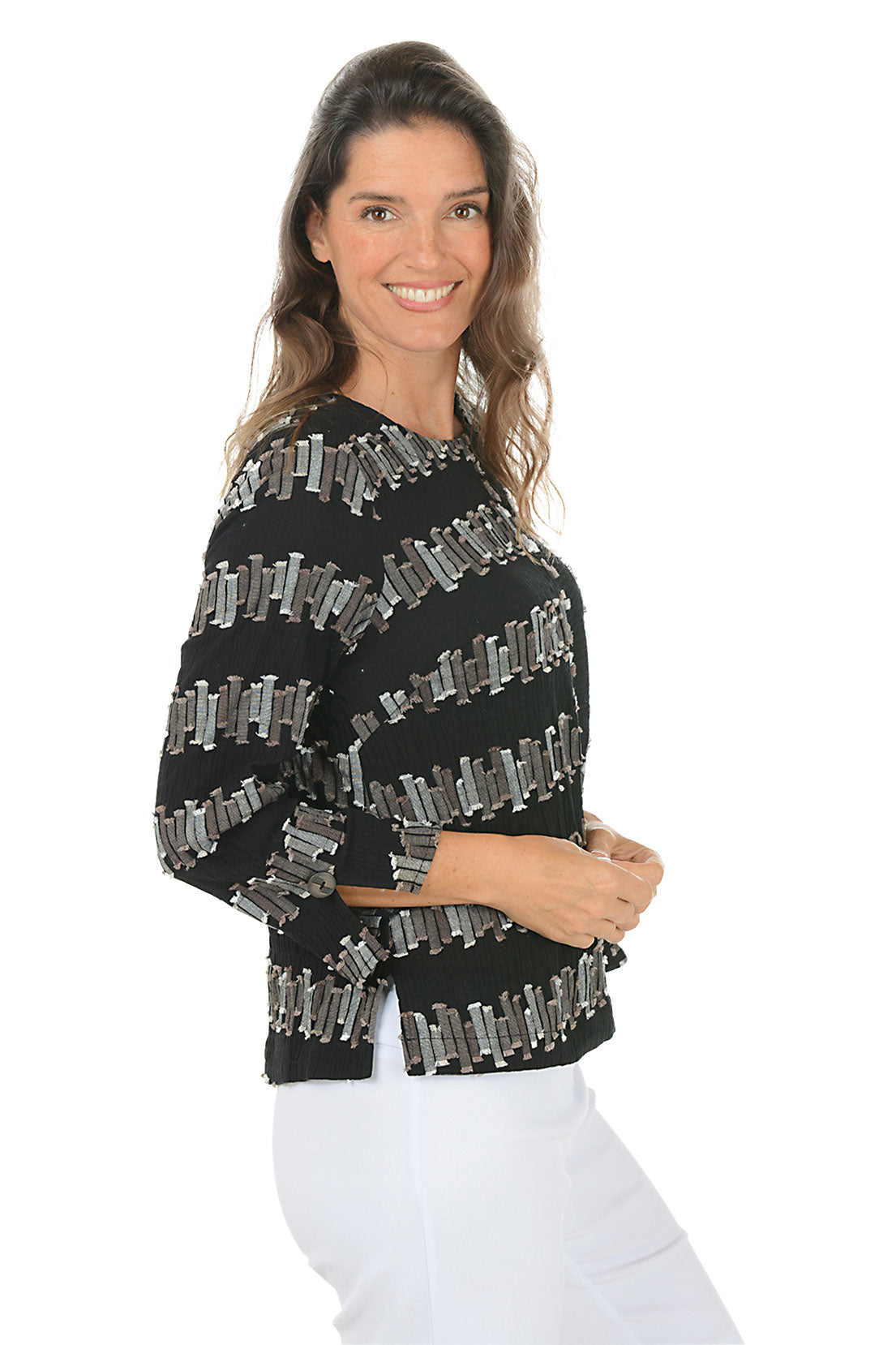 Woman wearing a black 3/4 sleeve shirt with silver embellishments on a white background. Side shot.