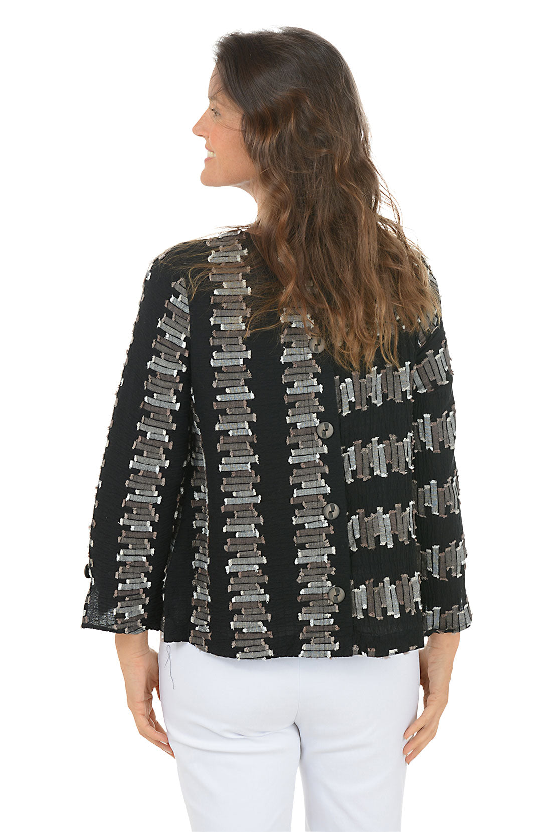 Woman wearing a black 3/4 sleeve shirt with silver embellishments on a white background. Back shot.