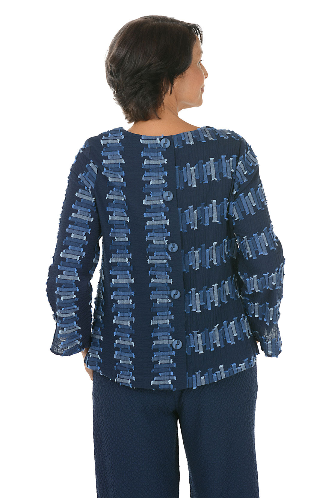 Woman wearing a blue patterned 3/4 sleeve top on a white background. Back shot.