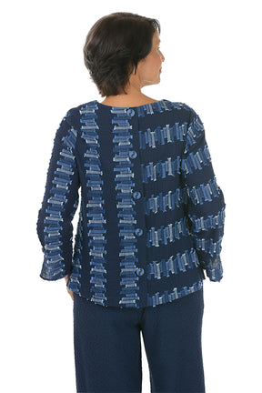 Woman wearing a blue patterned 3/4 sleeve top on a white background. Back shot.