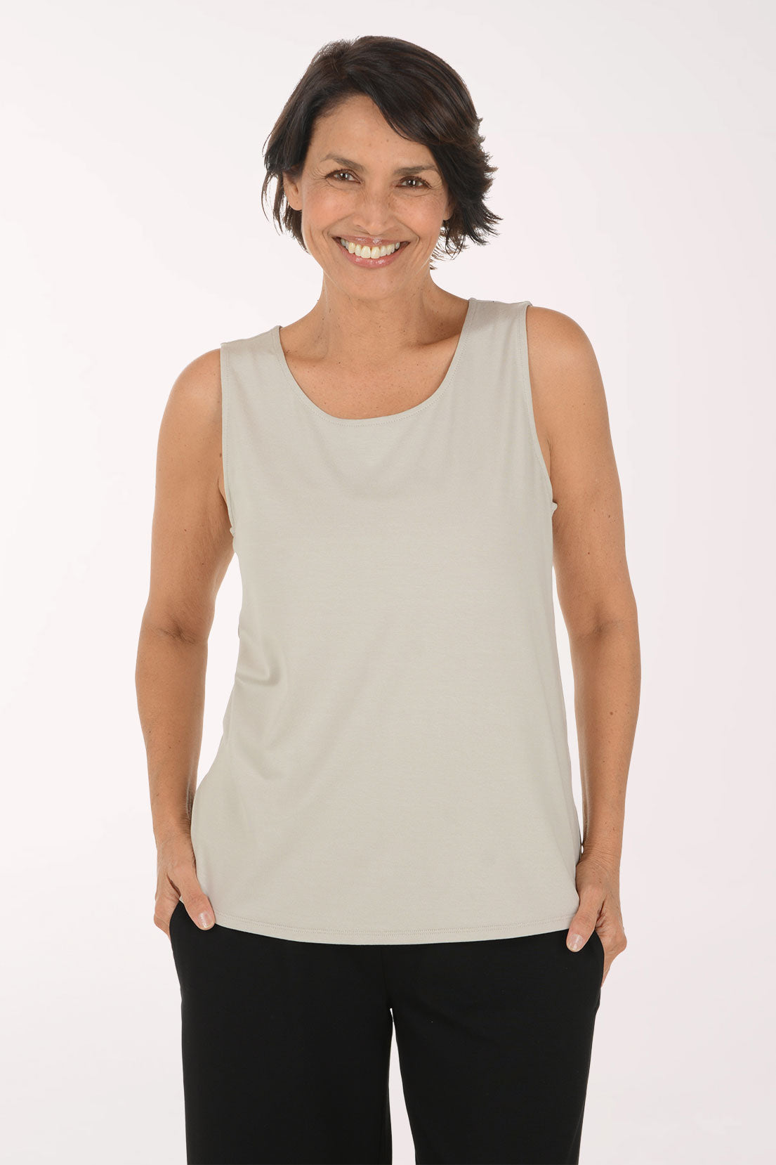 Woman wearing a solid beige tank top
