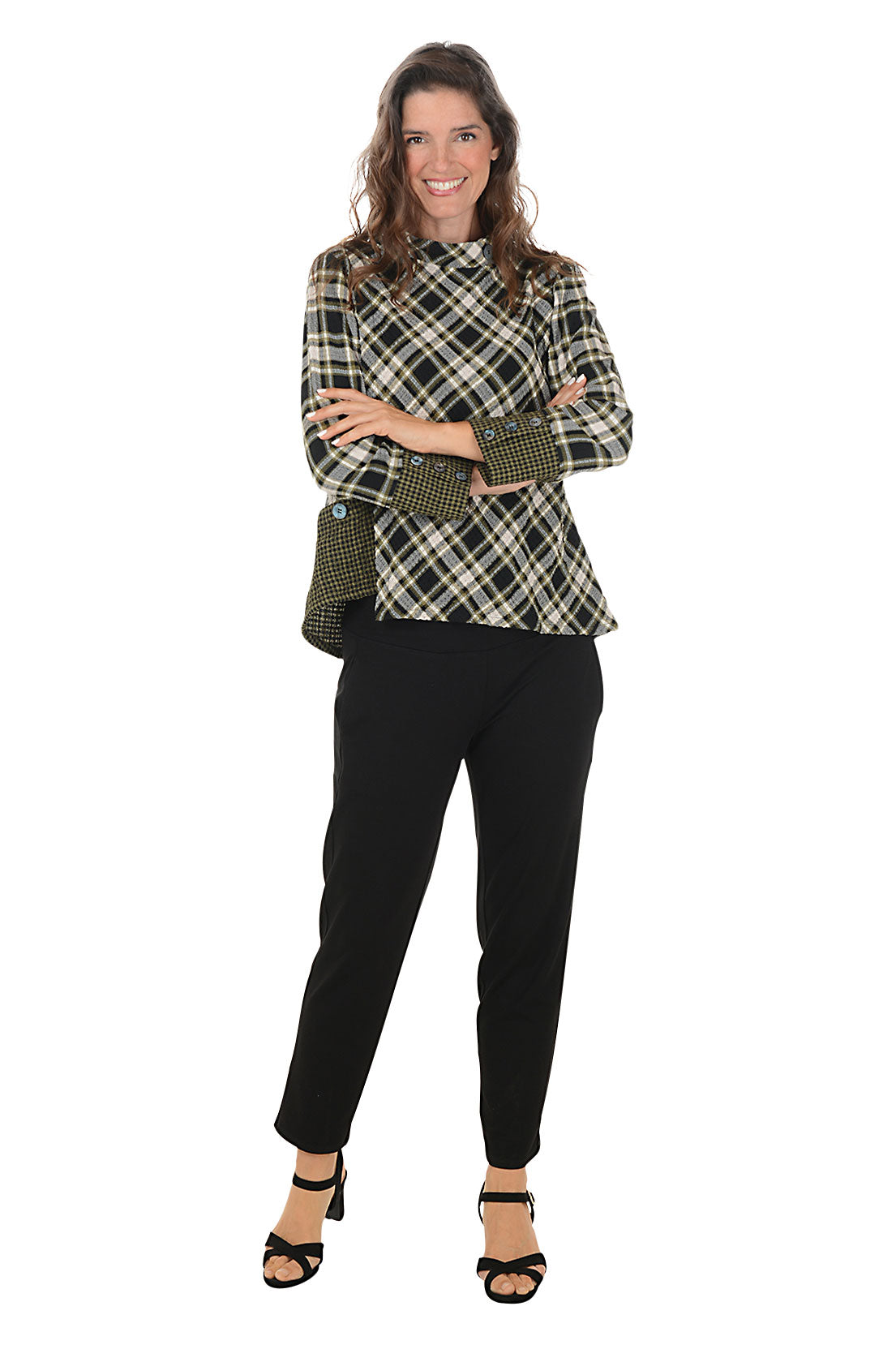 Woman wearing a plaid jacket and black pants on a white background.