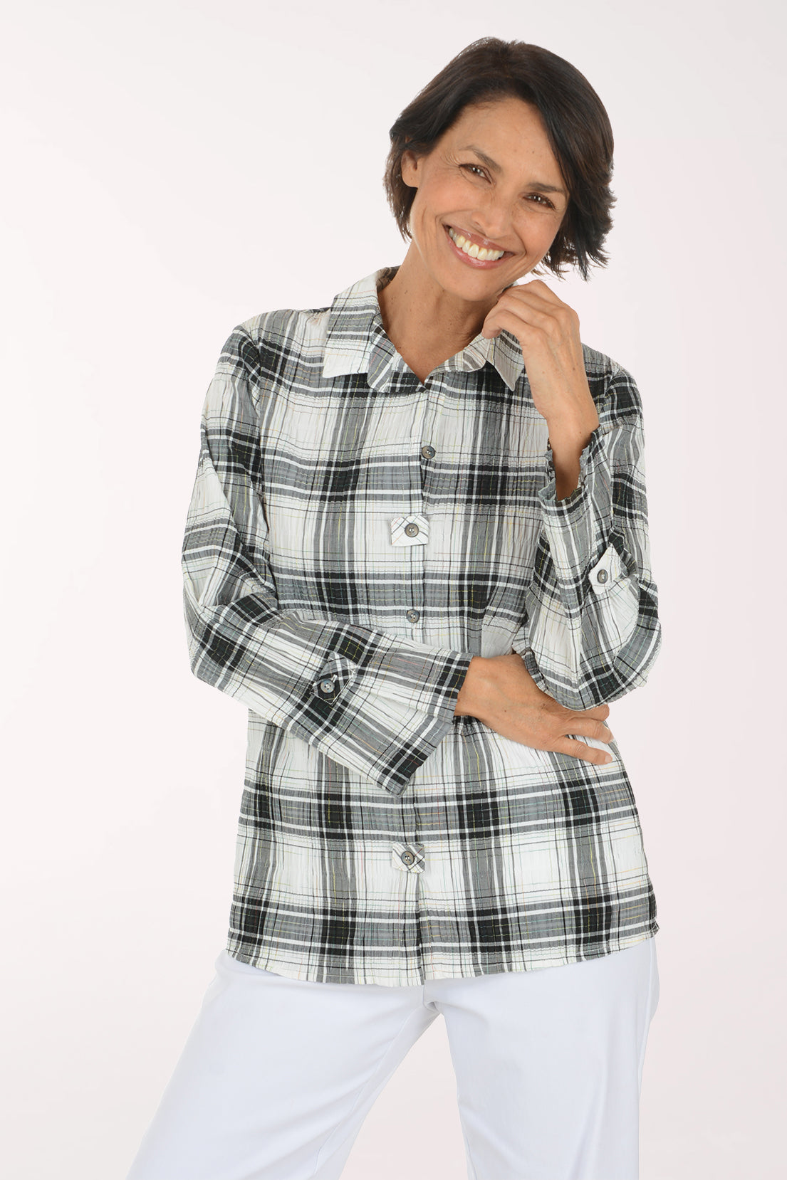 Woman wearing a black and white plaid collared top