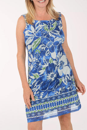 Woman wearing a blue floral dress on a white background