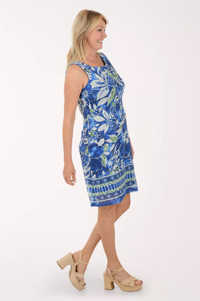 Woman wearing a blue floral dress on a white background