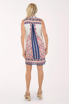 Woman wearing a white sleeveless dress with floral patterns on a white background