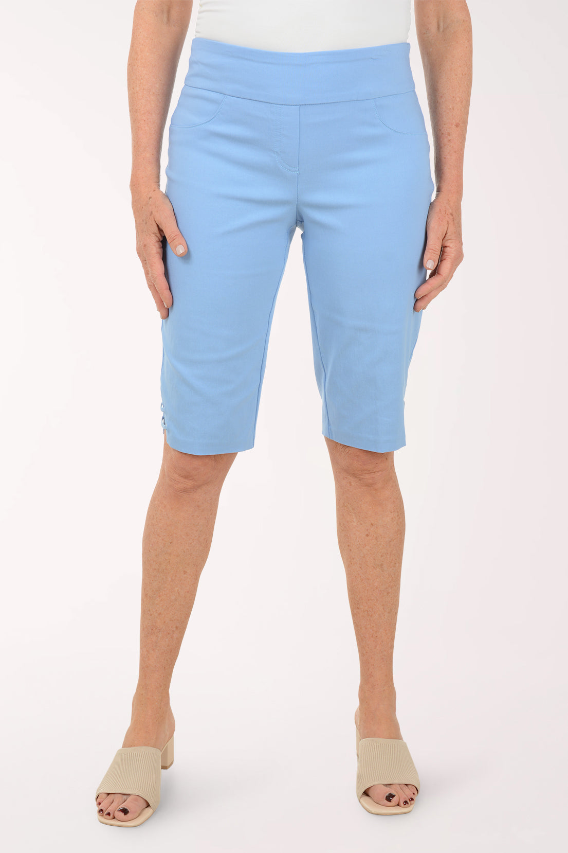 Light blue capri pants worn by a person on a white background