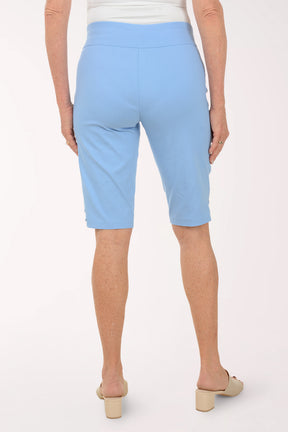 Light blue capri pants worn by a person on a white background