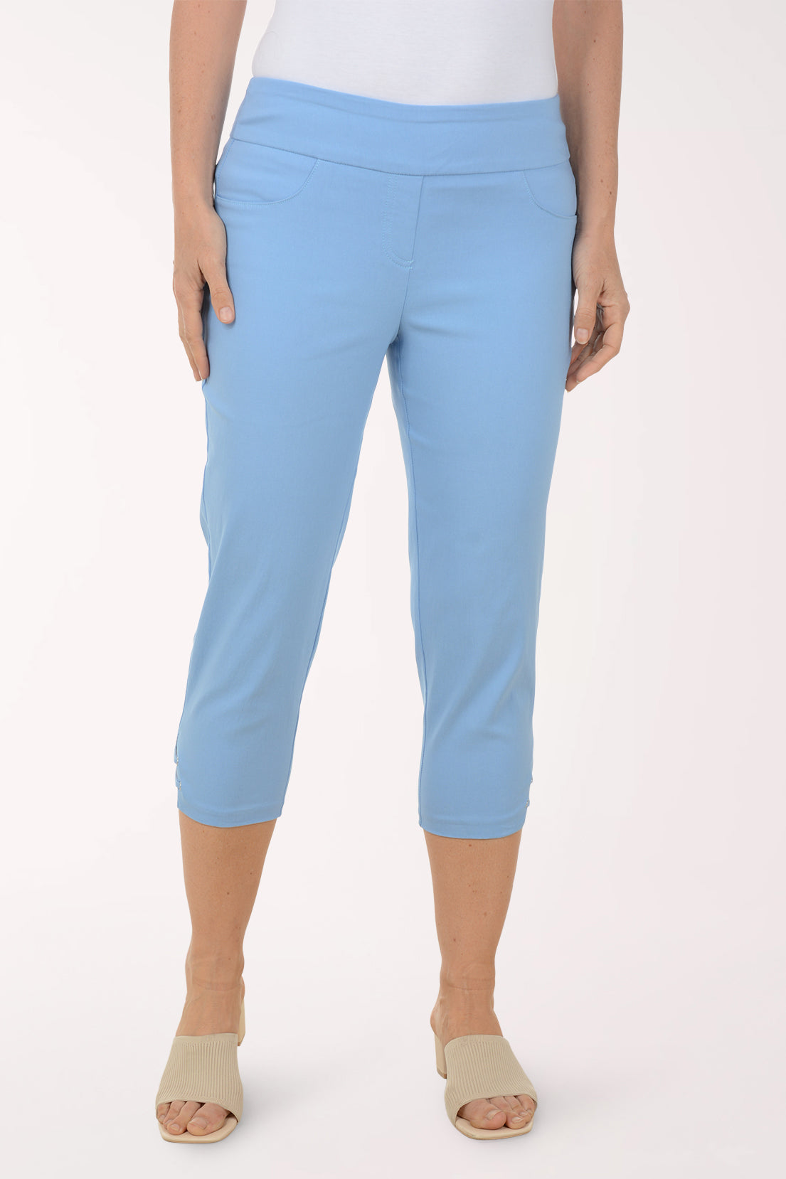 Light blue capri pants worn by a person on a white background