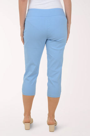 Light blue capri pants worn by a person on a white background