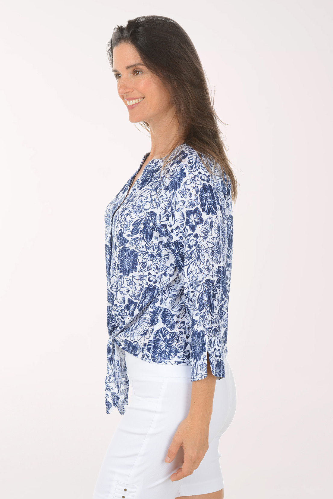 Woman wearing a blue floral blouse with a white background
