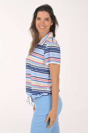 Woman wearing a colorful striped polo shirt and light blue pants on a white background