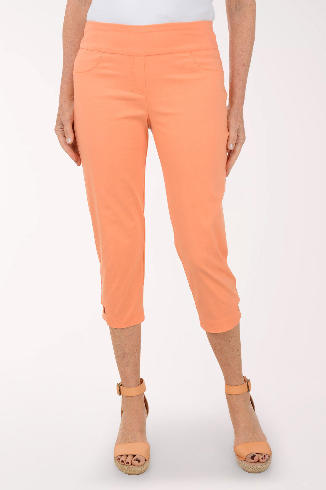 Person wearing orange pants on a white background