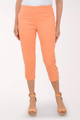 Person wearing orange pants on a white background