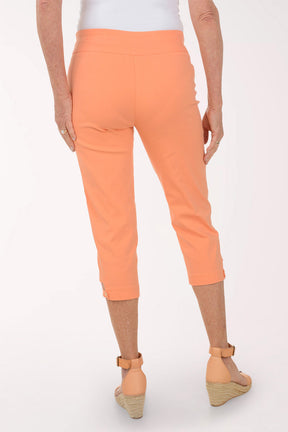Person wearing orange pants on a white background