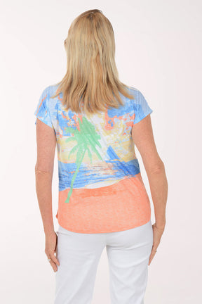 Woman wearing a colorful top with a white background