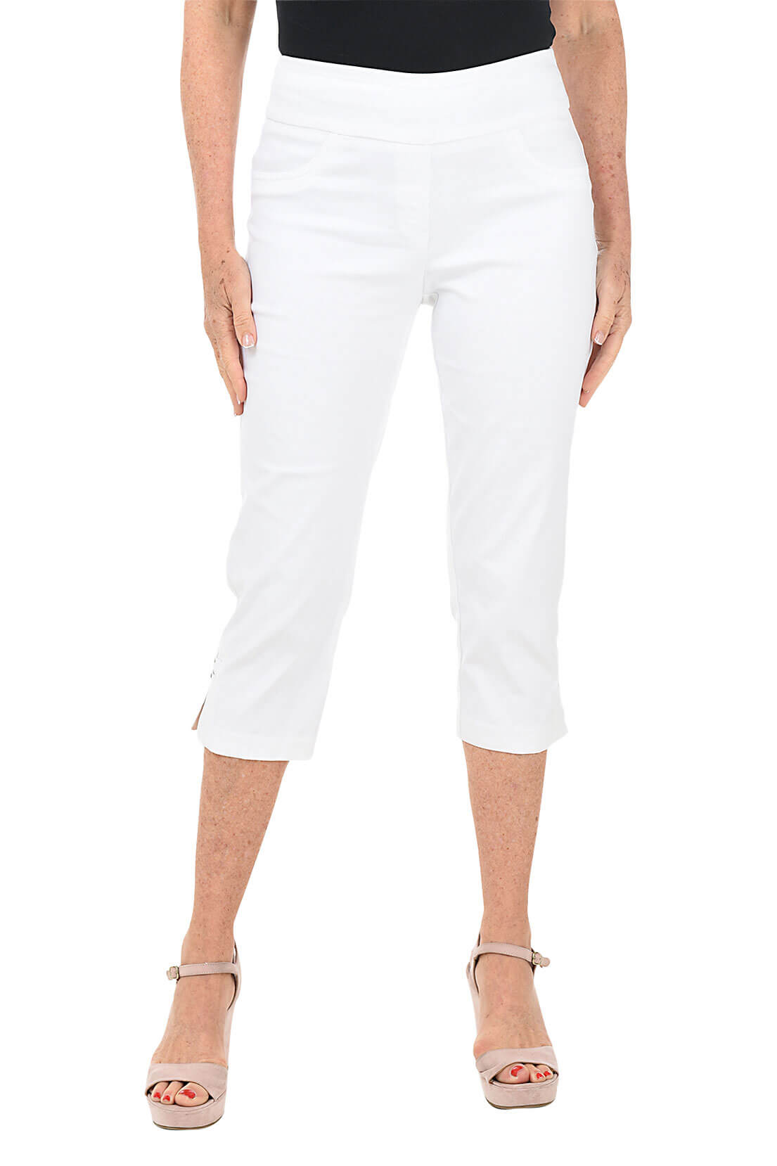 Person wearing white capri pants on a white background
