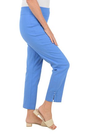 Woman wearing blue pants on a white background. Side shot.