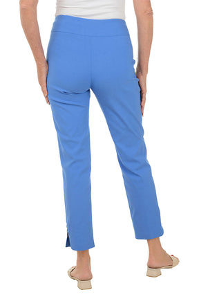 Woman wearing blue pants on a white background. Back shot.