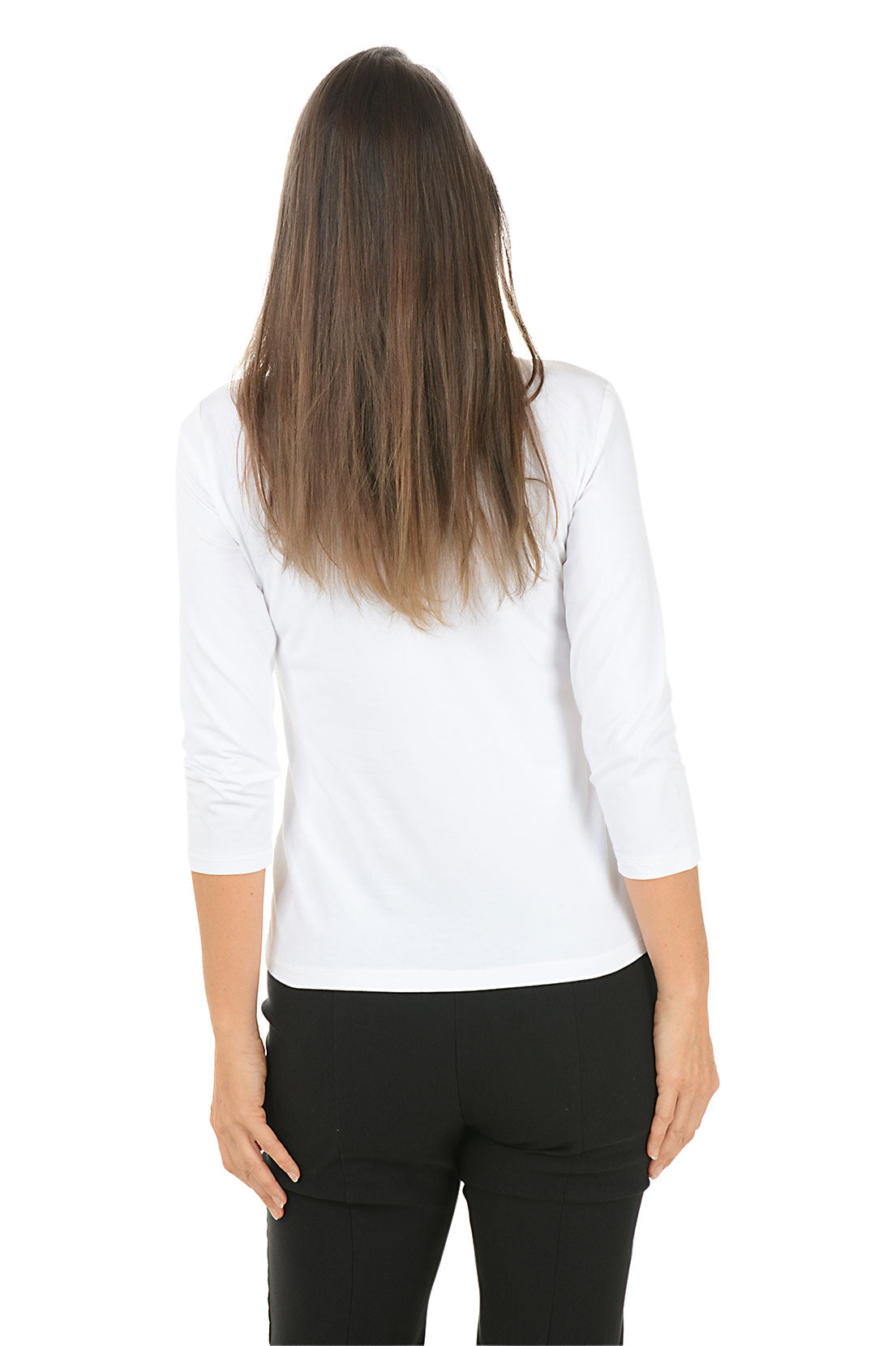 Woman wearing a white long-sleeve top with black pants on a white background. Back shot.