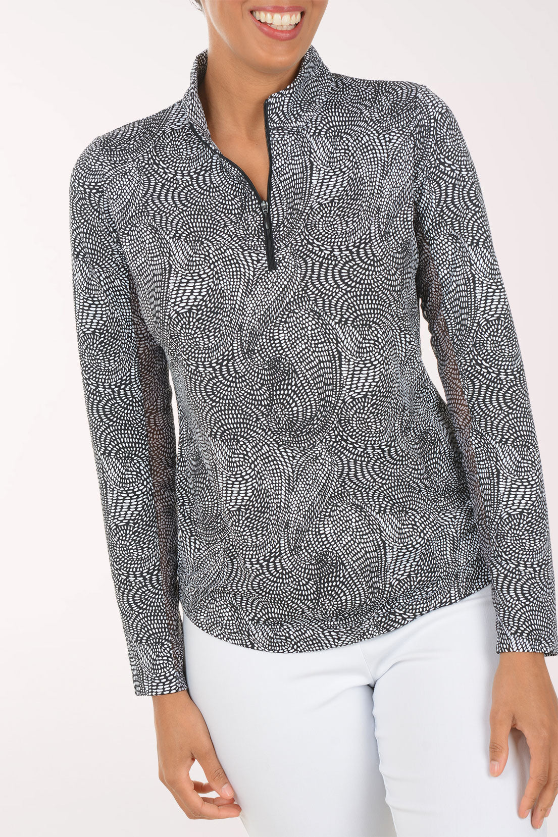 Woman wearing a patterned long-sleeve shirt on a white background