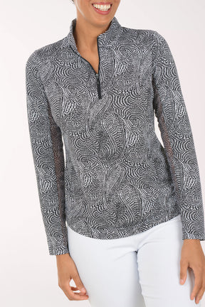 Woman wearing a patterned long-sleeve shirt on a white background