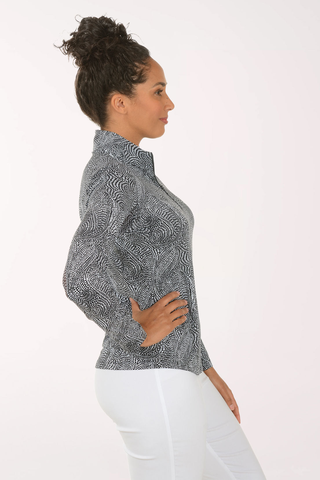 Woman wearing a patterned long-sleeve shirt on a white background