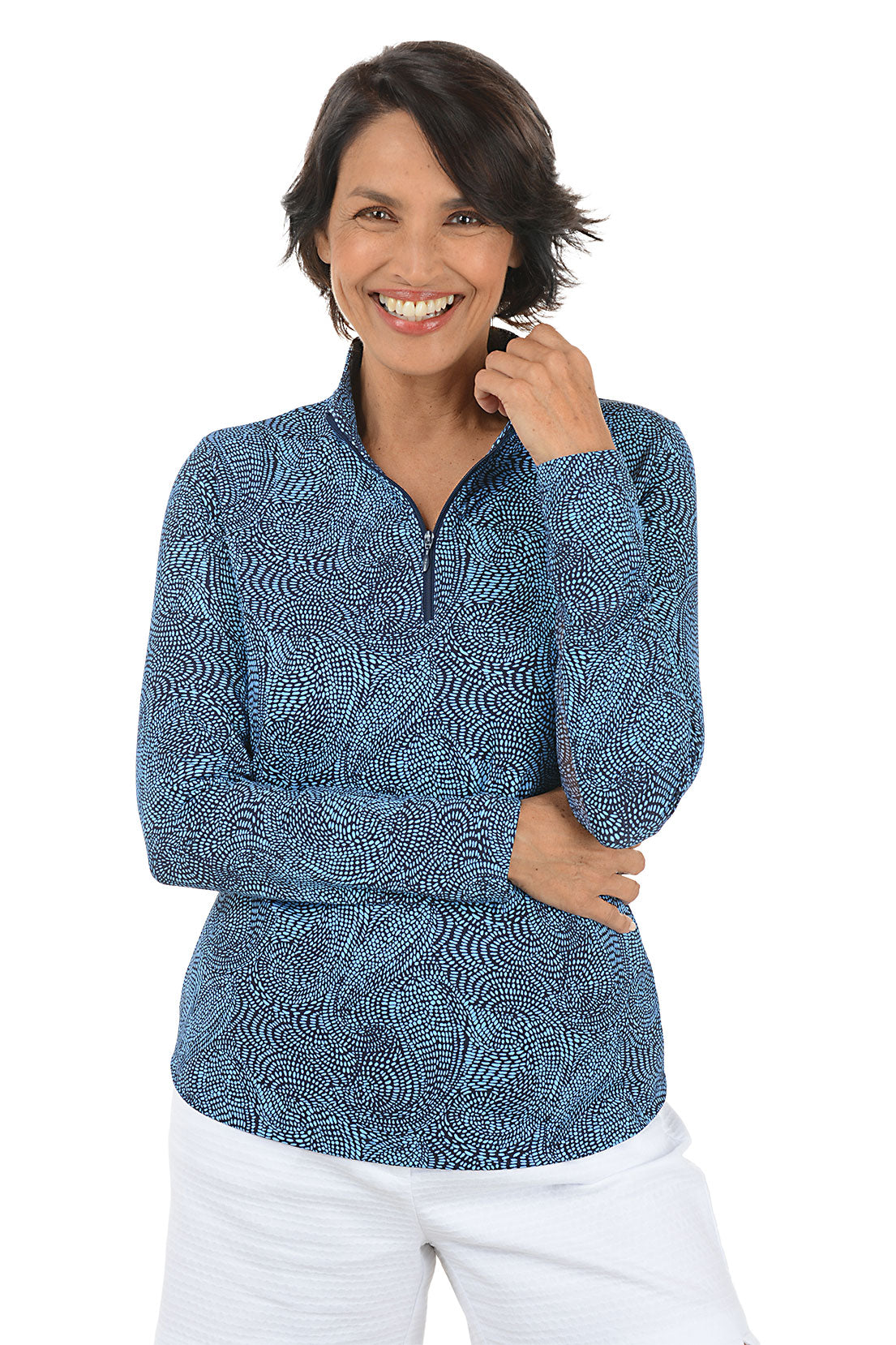 Woman wearing a blue patterned long-sleeve shirt on a white background