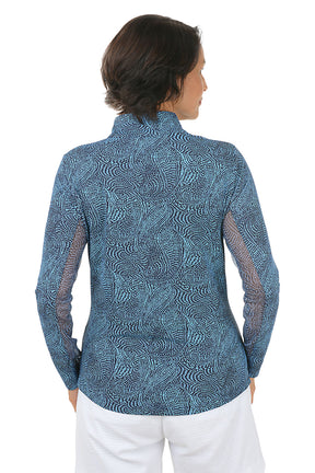 Woman wearing a blue patterned long-sleeve shirt on a white background