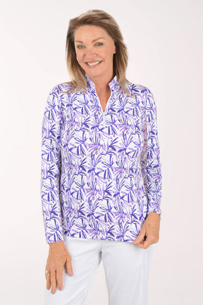 Woman wearing a purple floral patterned shirt on a white background