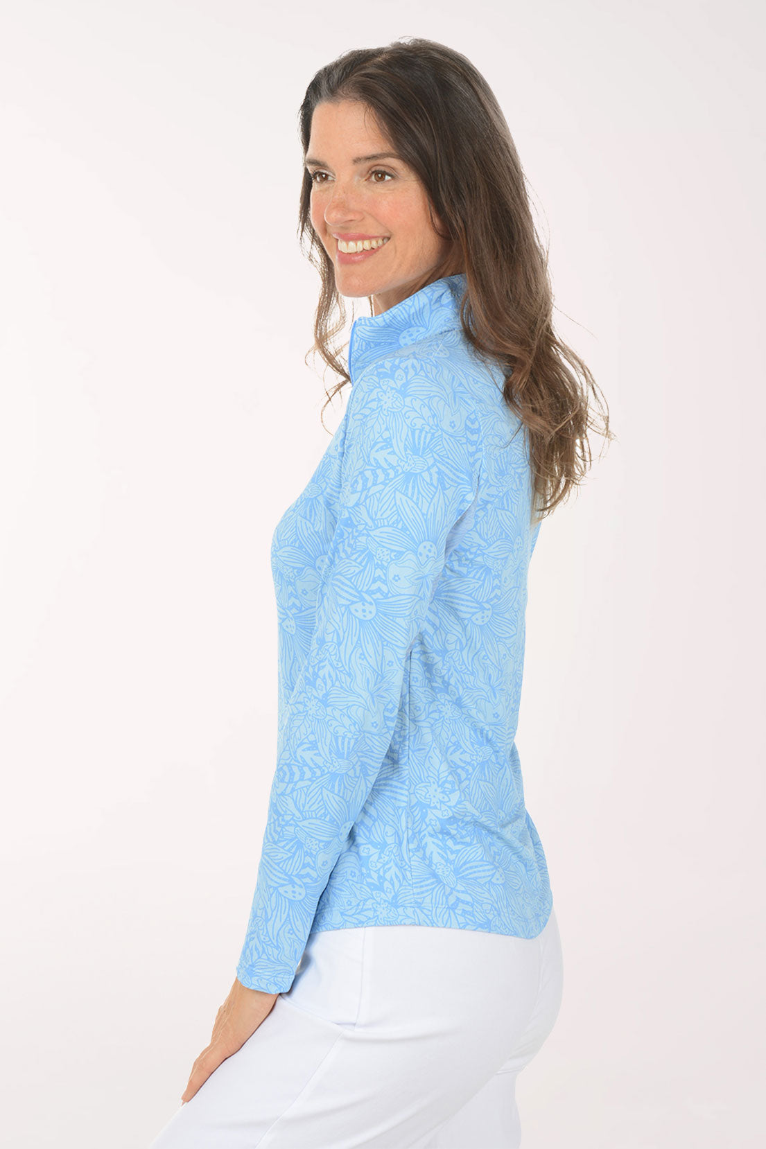 Woman wearing a light blue long-sleeve shirt with mesh accents on a white background