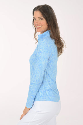 Woman wearing a light blue long-sleeve shirt with mesh accents on a white background