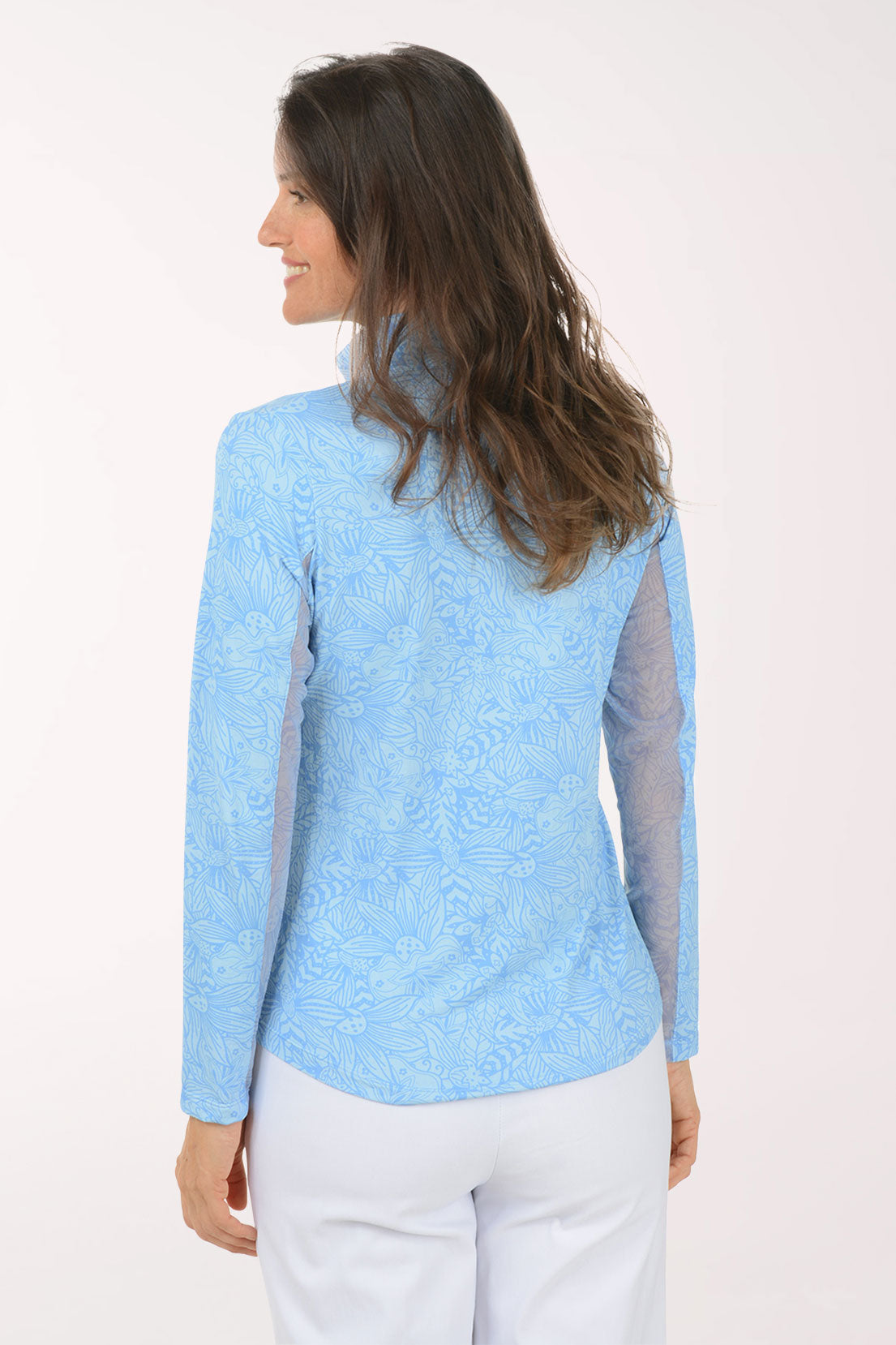 Woman wearing a light blue long-sleeve shirt with mesh accents on a white background