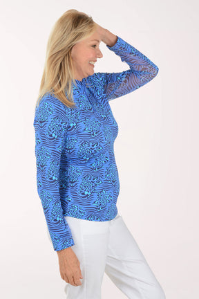 Woman wearing a blue patterned long-sleeve shirt on a white background