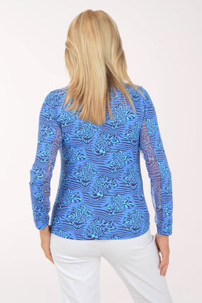 Woman wearing a blue patterned long-sleeve shirt on a white background
