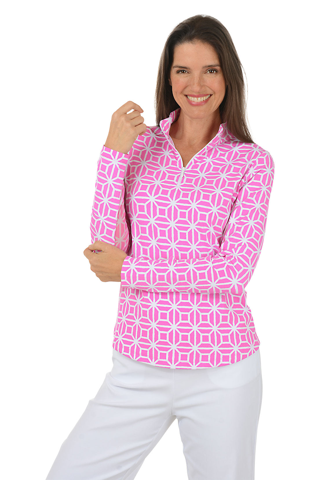 Woman wearing a pink geometric patterned shirt with white pants on a white background