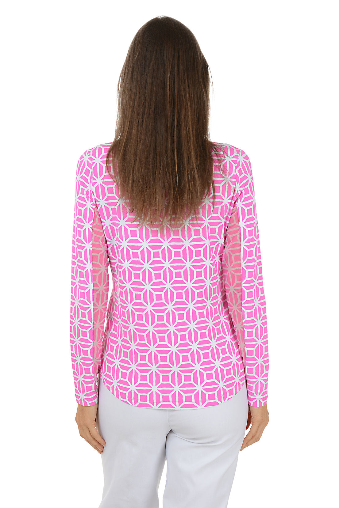 Woman wearing a pink geometric patterned shirt with white pants on a white background