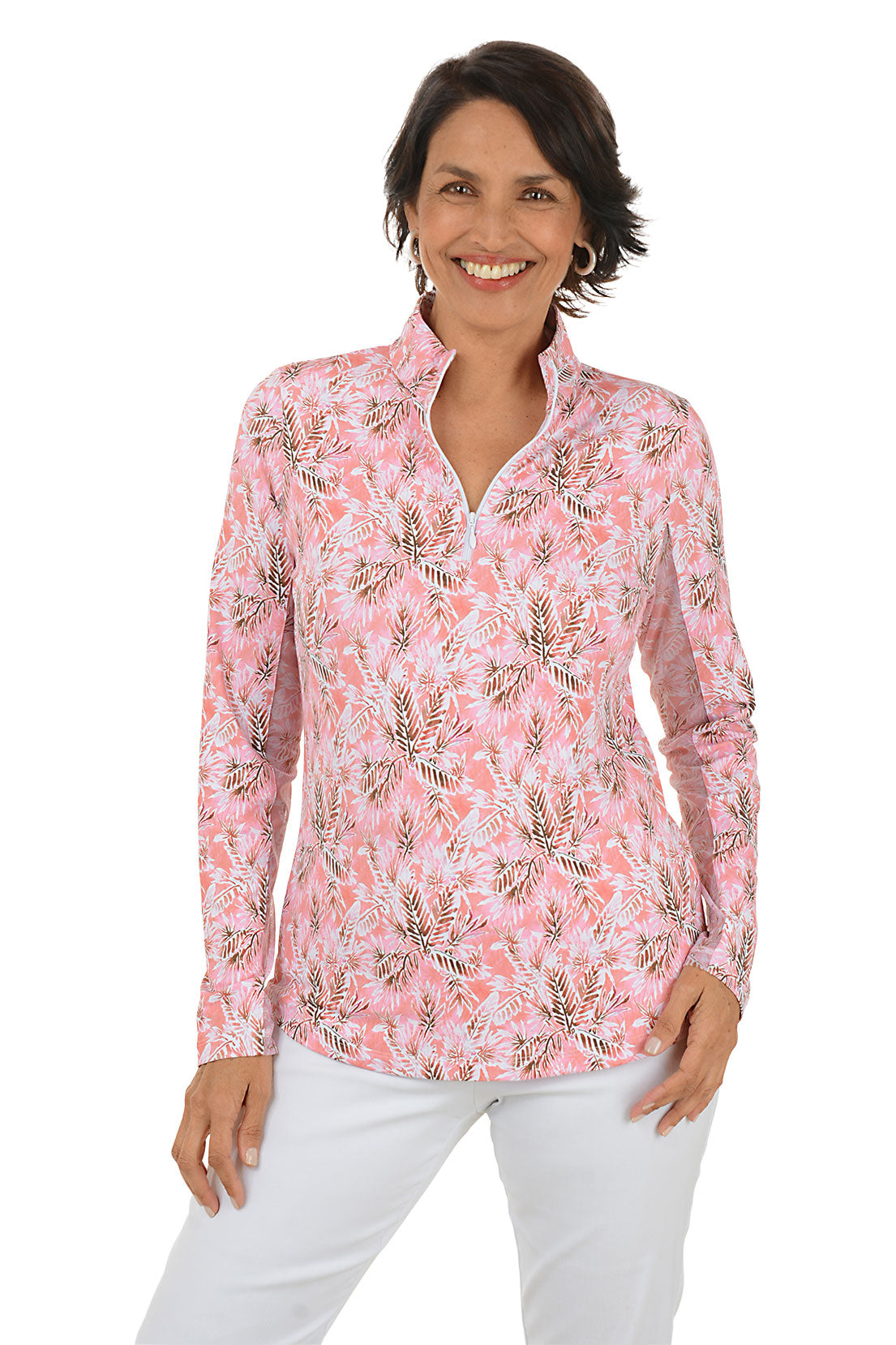 Woman wearing a pink floral blouse with white pants on a white background