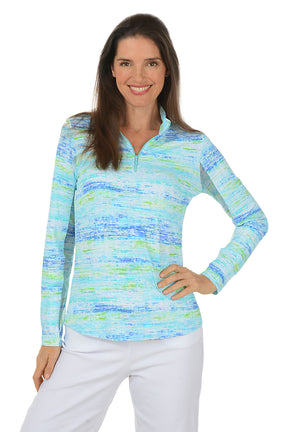 Woman wearing a colorful long-sleeve shirt with a white background