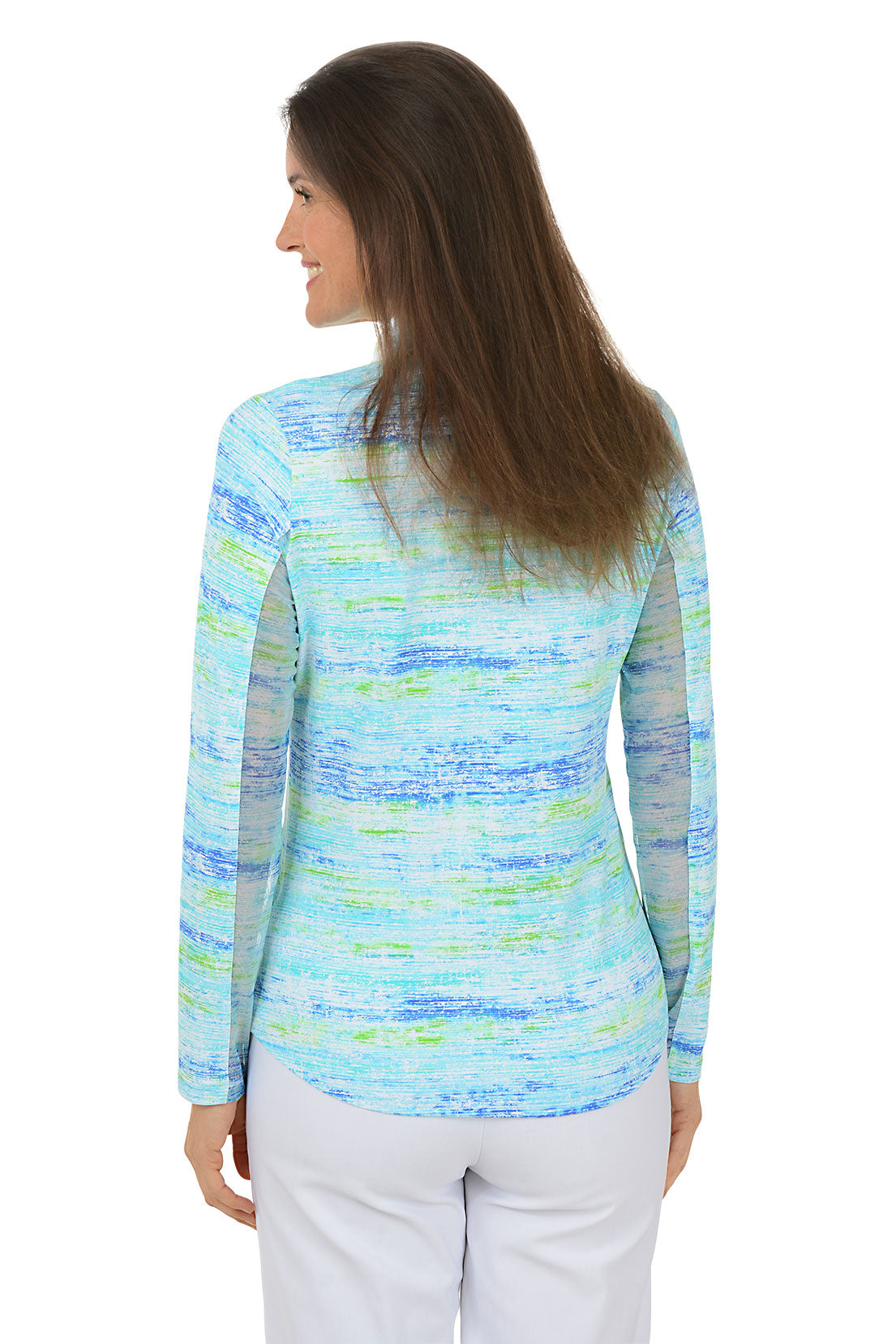 Woman wearing a colorful long-sleeve shirt with a white background